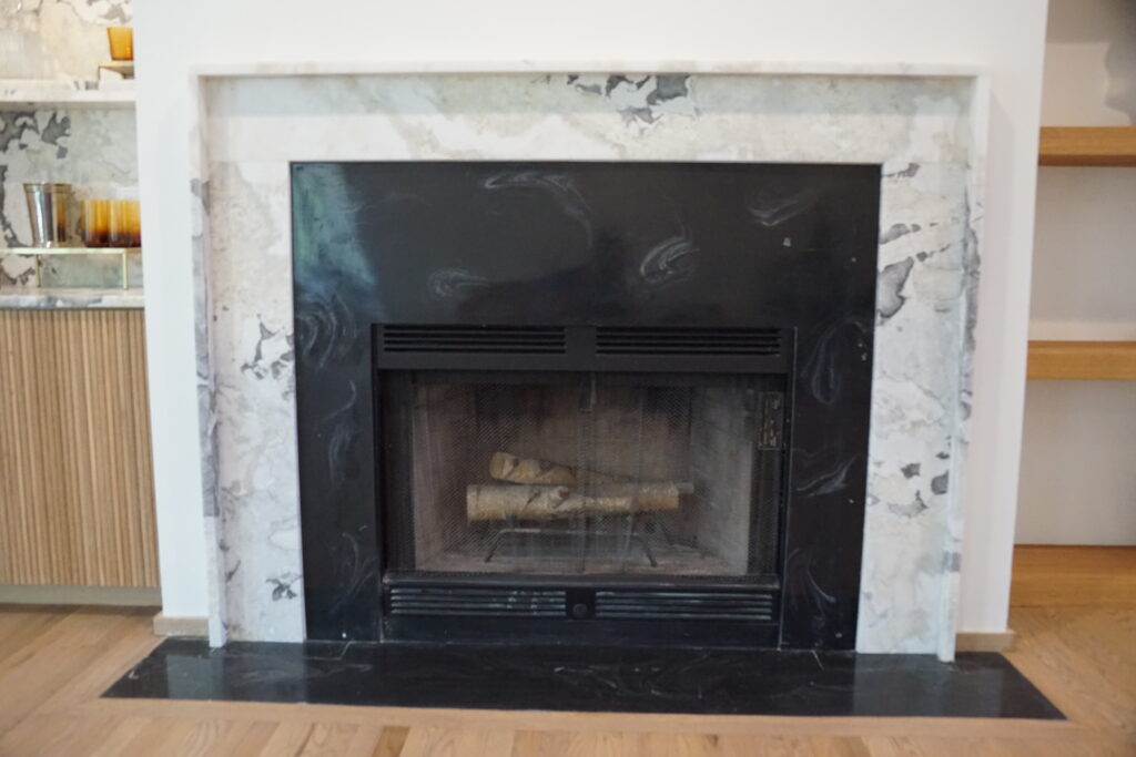 Oyster White Honed Marble Stone Fireplace made by the Granite Guys, LLC. in Mount Pleasant, South Carolina.